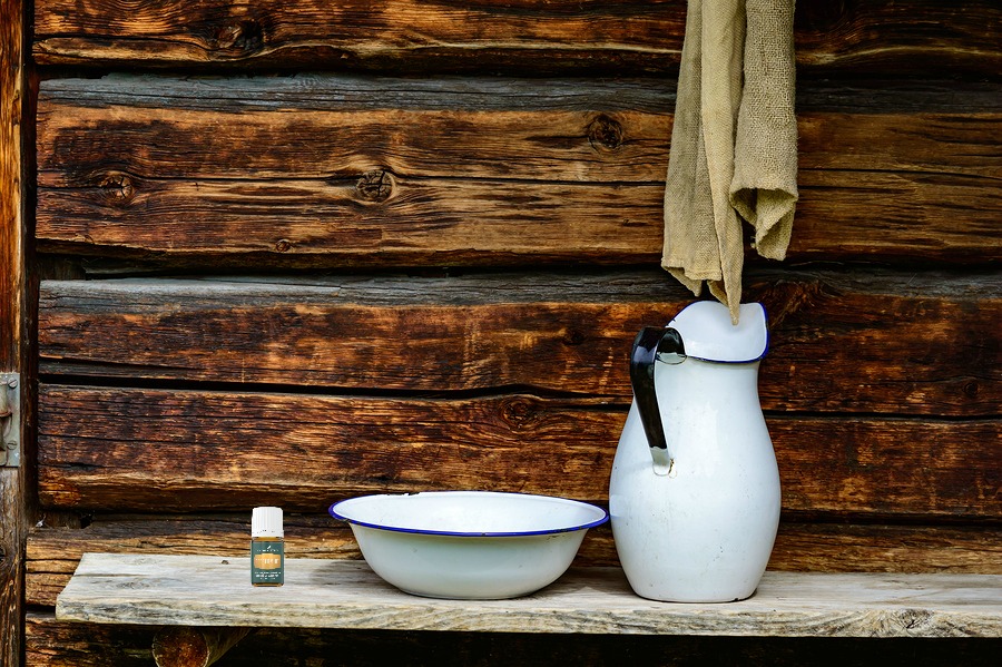Place to wash up with white jug and bowl for water and a rugged cloth to dry with. Timber facade with copy space.