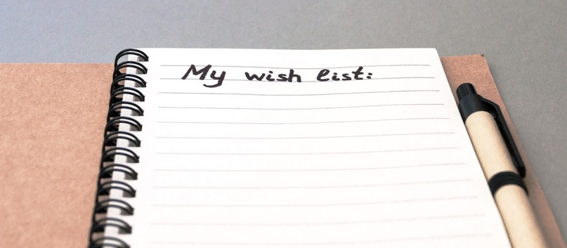 Hand drawing wish list on notebook from recycling paper on grey background with handle