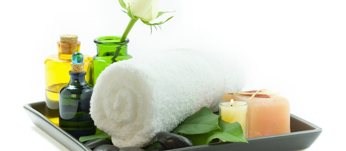 relaxation spa set with candles, essential oils, towel, pebbles