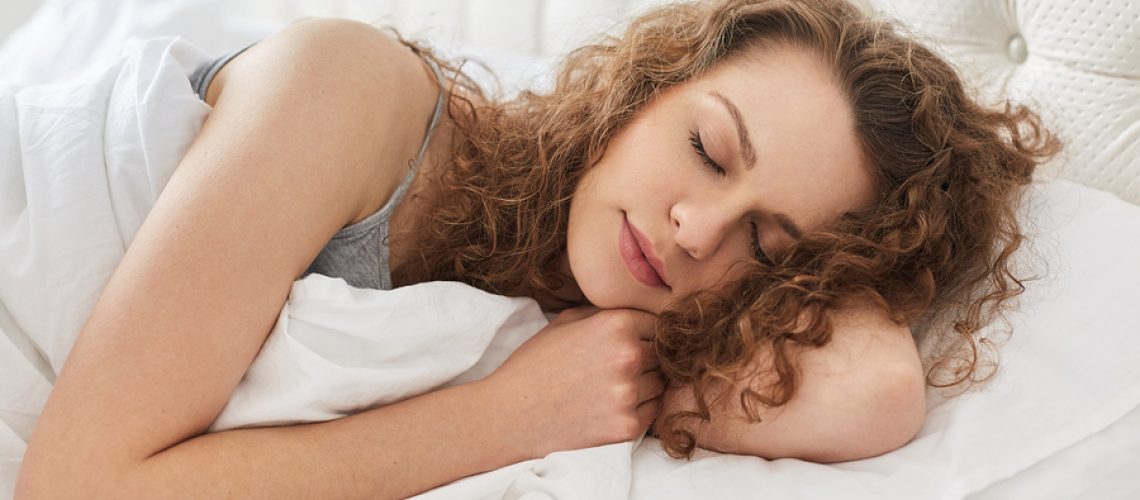 Horizontal Shot Of Pretty Young Woman Sleeps Sweetly At Bed, See